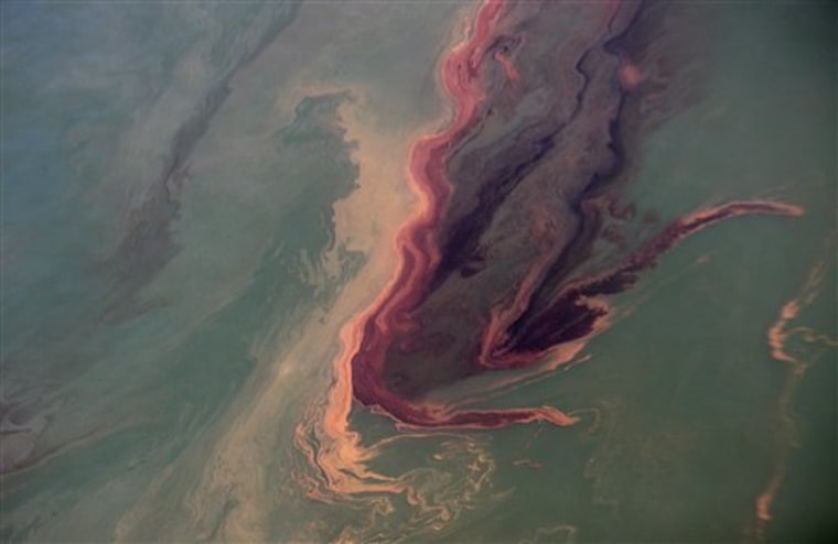 An oil slick is near the site of the Deepwater Horizon oil spill contrasts with the water in the Gulf of Mexico on Sunday. Oil continues to flow from the wellhead some 5,000 feet below the surface. 